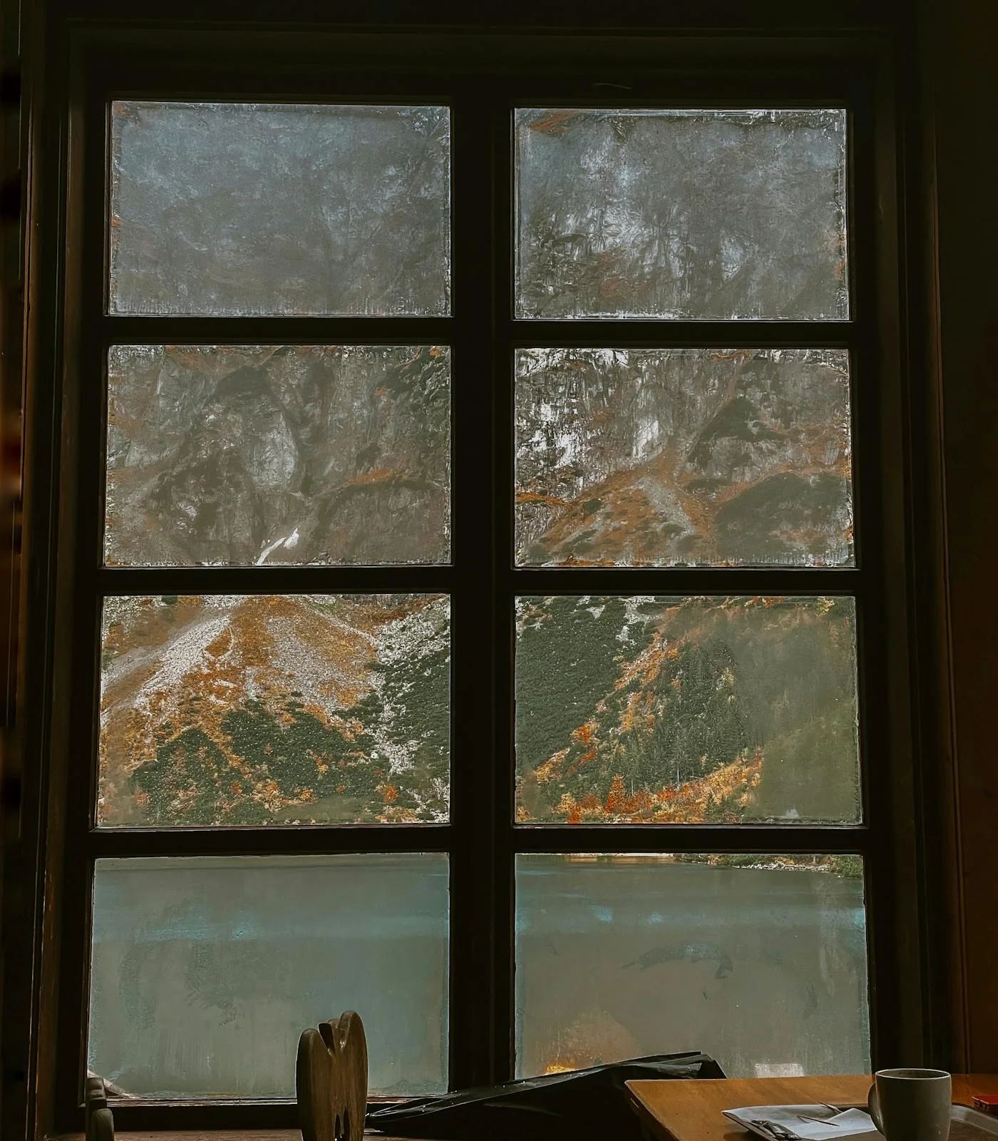 Mountain and lake view through a lodge window